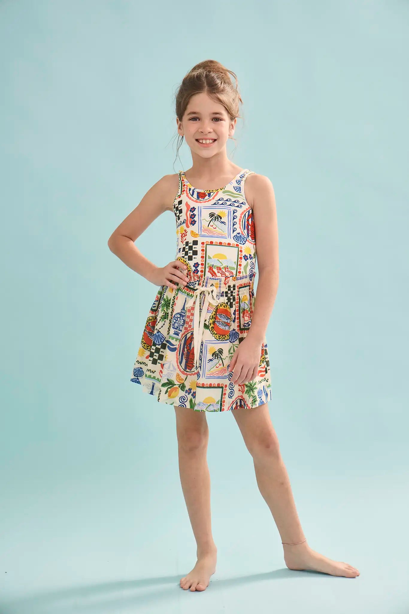 The Kids Tank Swimsuit in Coastal Conversation paired with matching rosie skirt