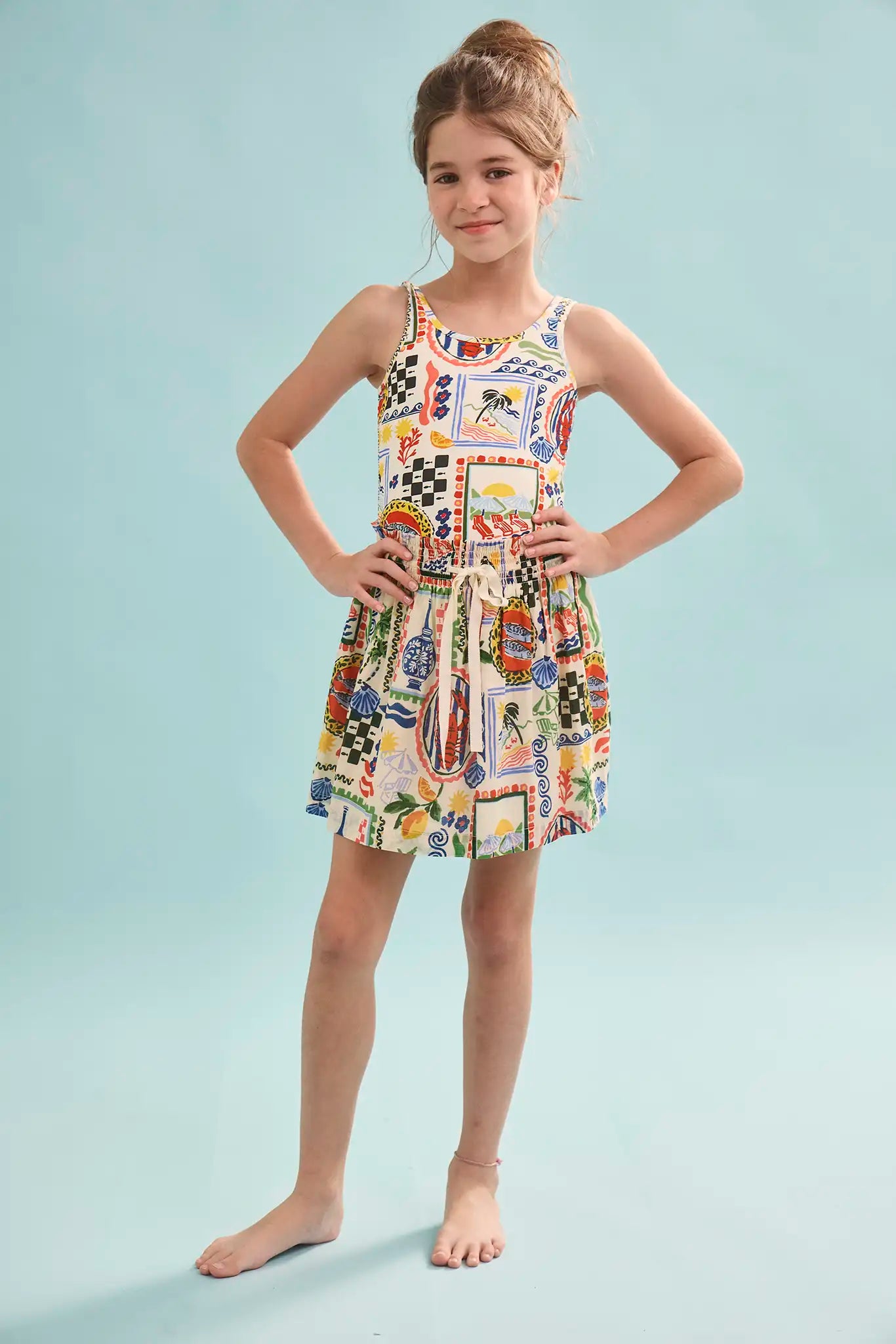 The Kids Tank Swimsuit in Coastal Conversation paired with matching rosie skirt
