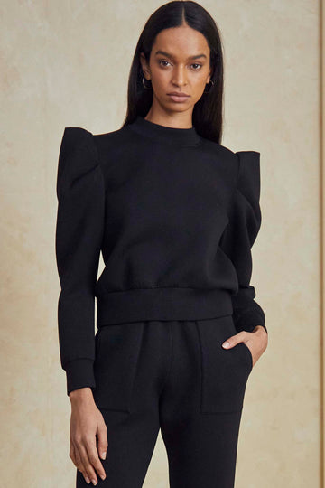 The Teddy puff sleeve sweatshirt has a crew neckline, a center back zipper and a banded waist.