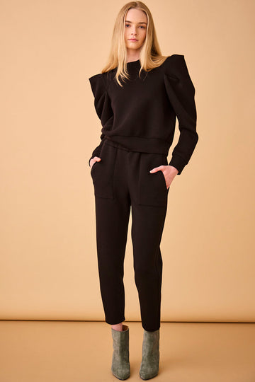 The Siegle Pant has a covered, elastic waistband, patch front and back pockets, and a tapered leg.