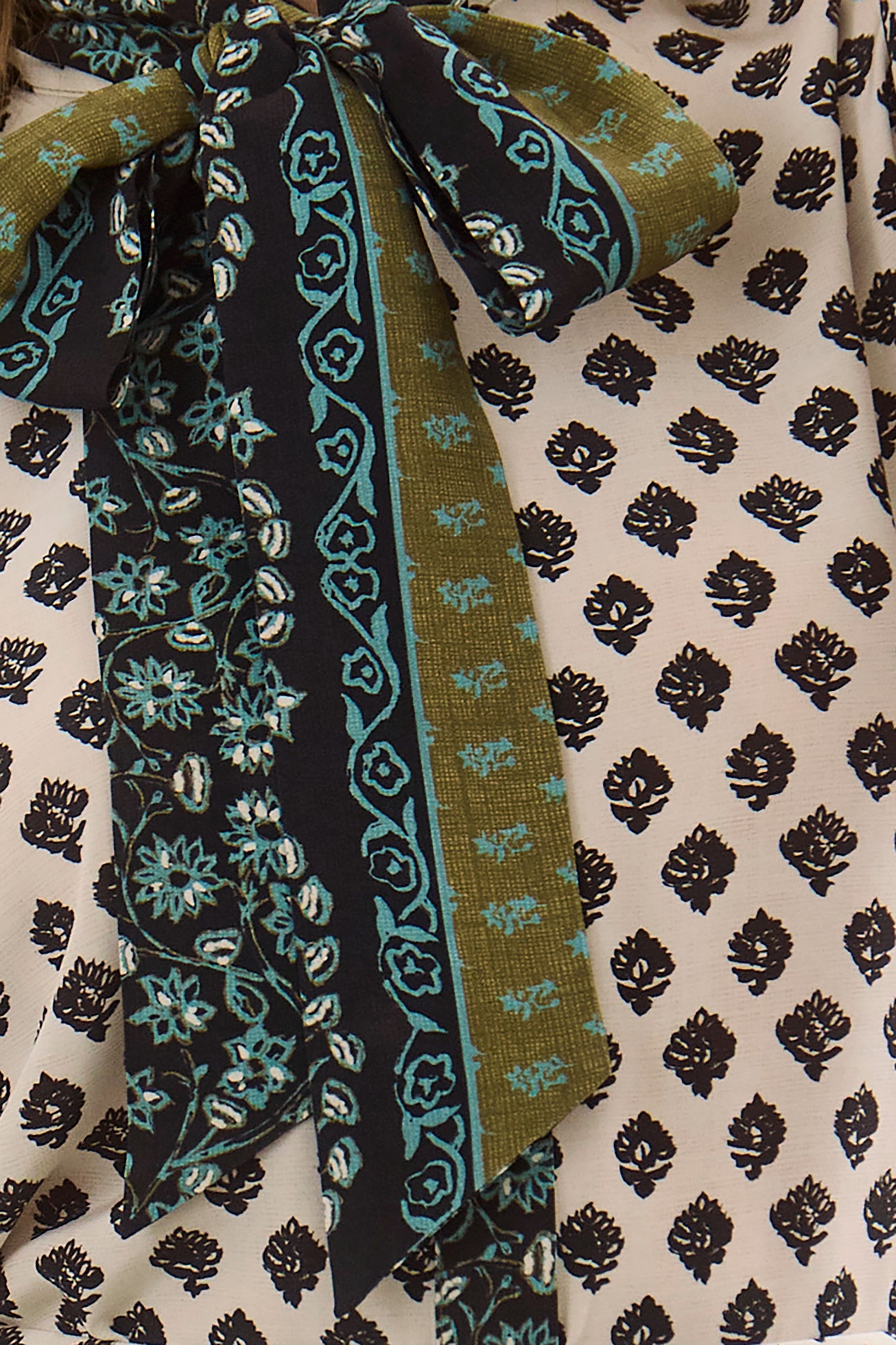 Close up of the Tess Blouse in Thistle and Vine Cream. 