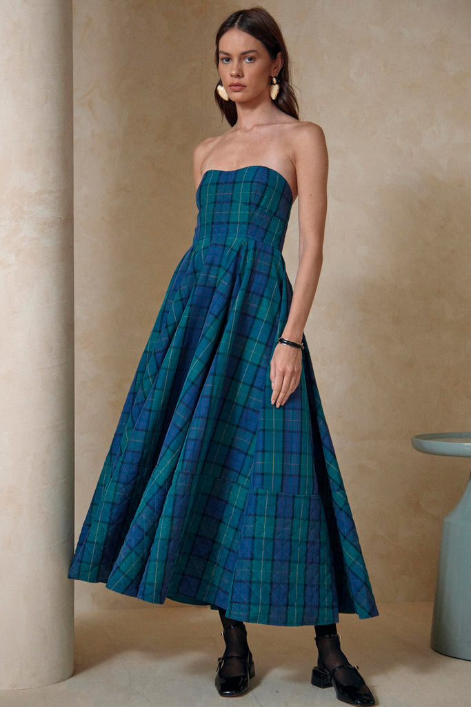 A strapless midi dress with a fitted bodice, a full godet hem skirt, and a separate belt.