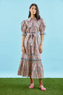 An open V-neckline with a ruffled collar, elbow length puff sleeves with tie details.
