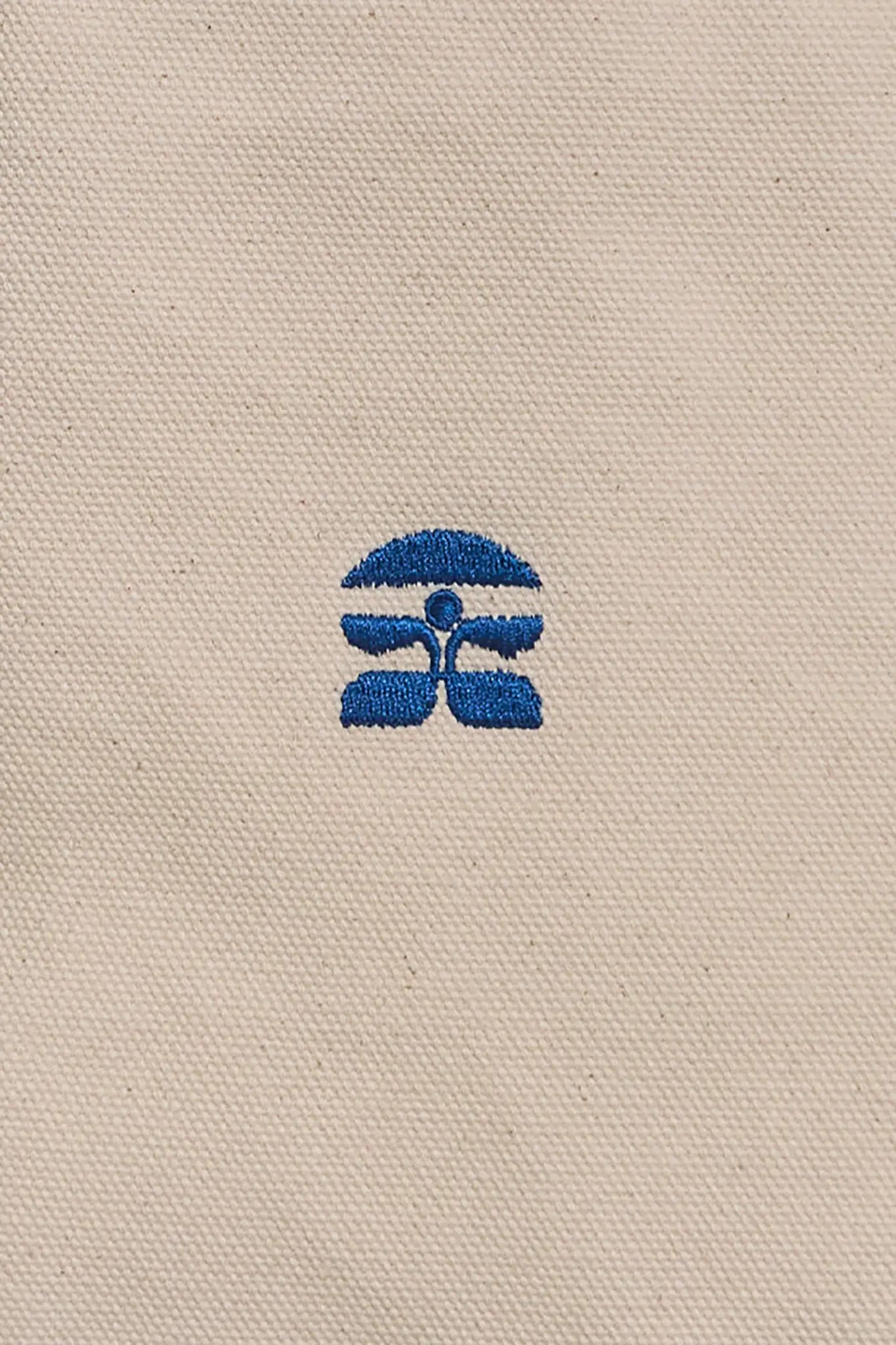 The medium canvas tote bag with green handles and fish motifs