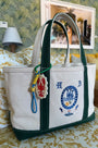 The medium canvas tote bag with green handles and fish motifs