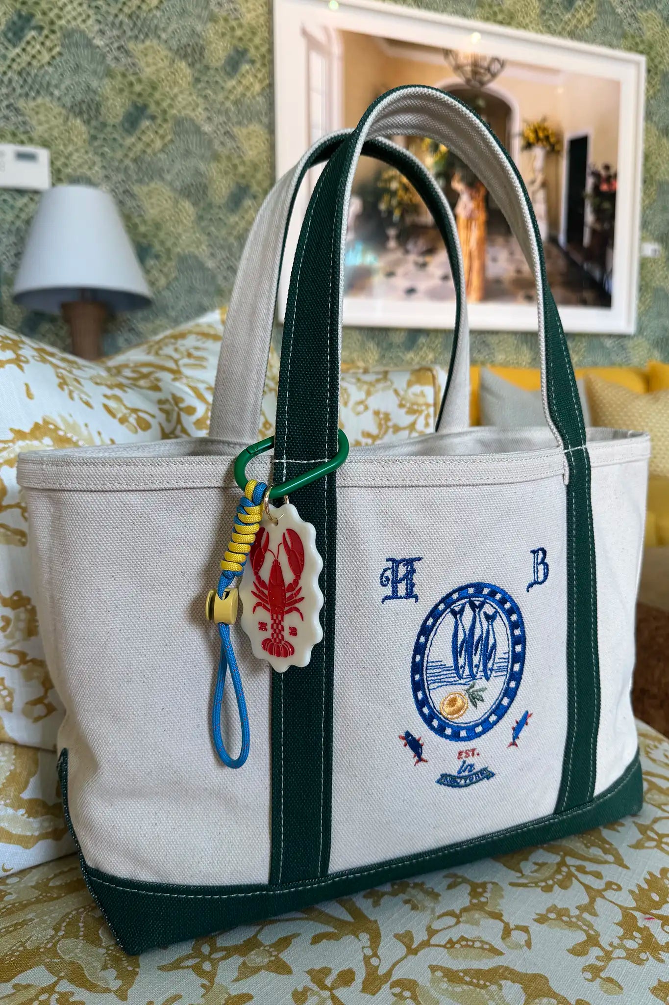 The medium canvas tote bag with green handles and fish motifs