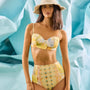 Bikini Top & Bikini Bottom in Still Life Symphony modeled in front of blue wall.
