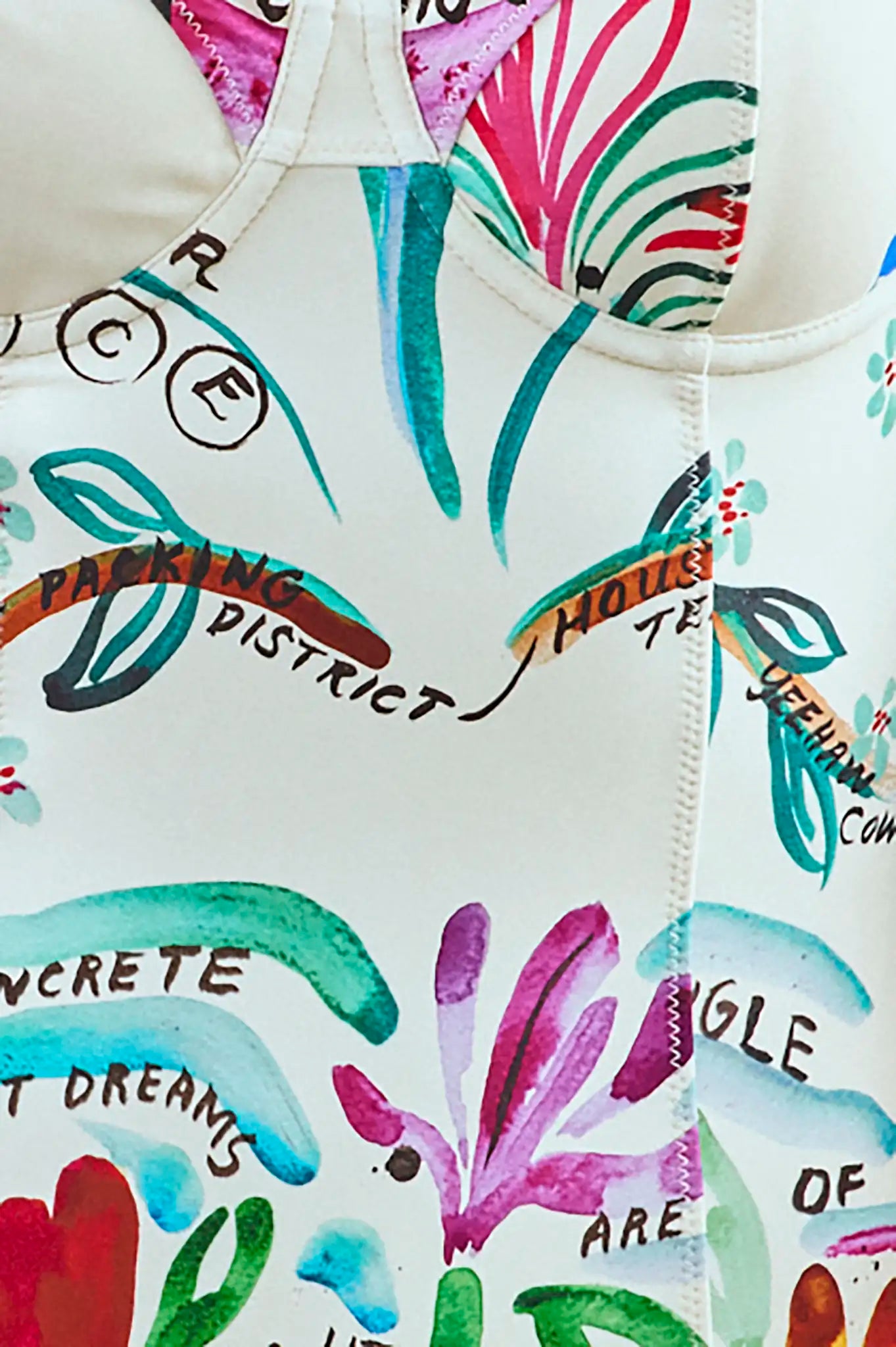 A one-piece white swimsuit with a colorful pattern, underwire bra top, and princess seam details.