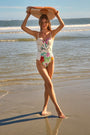 A one-piece white swimsuit with a colorful pattern, underwire bra top, and princess seam details.