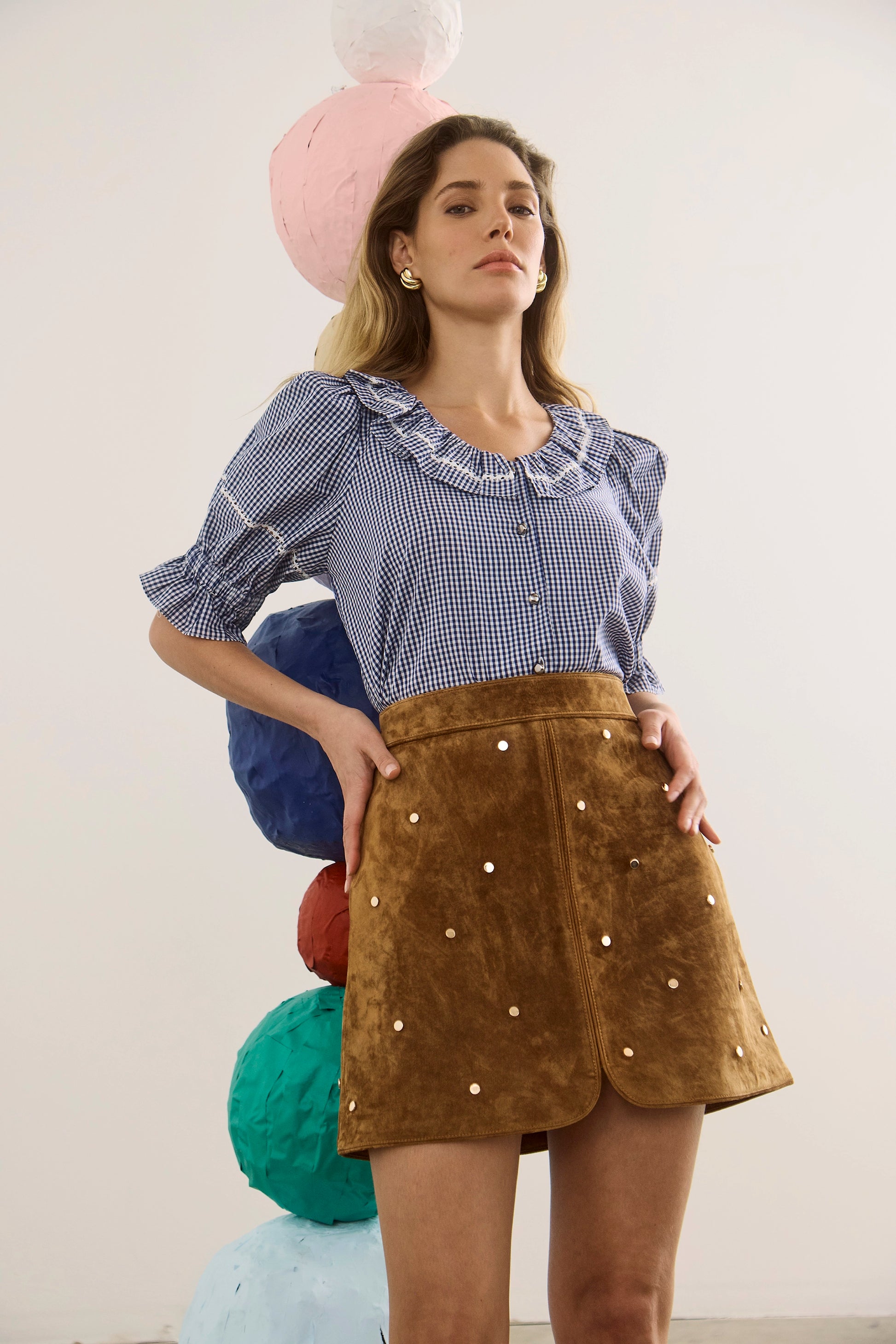 The Valene Blouse in Checkmate Navy paired with the Dottie Mini Skirt in Saddle. 