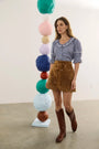 The Valene Blouse in Checkmate Navy paired with the Dottie Mini Skirt in Saddle. 
