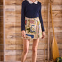 Skirt with a banded waist and sleek wrap silhouette with discreet snap closure.