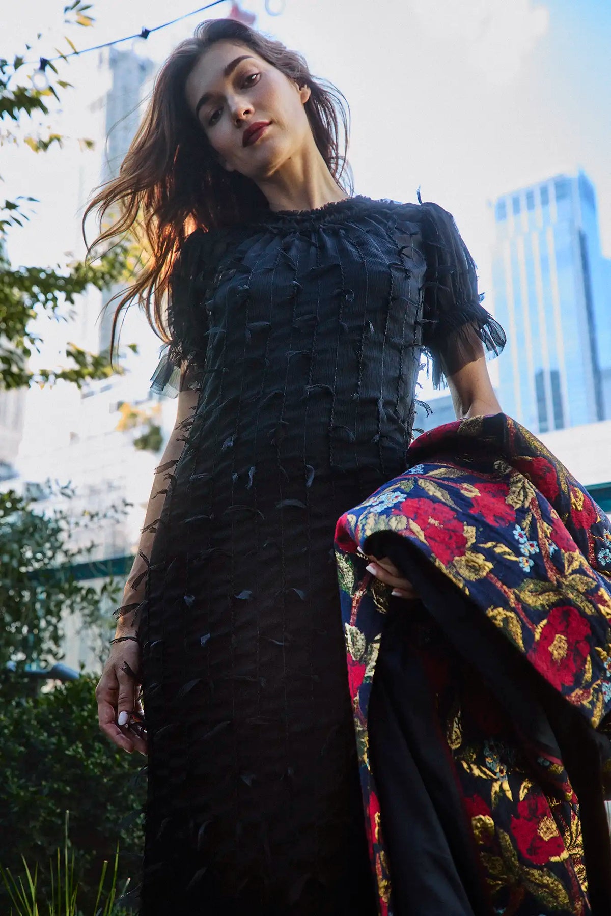 The Whitney Dress in Manhattan Chiffon Onyx paired with the Portman Coat in Palais Floral Gold.