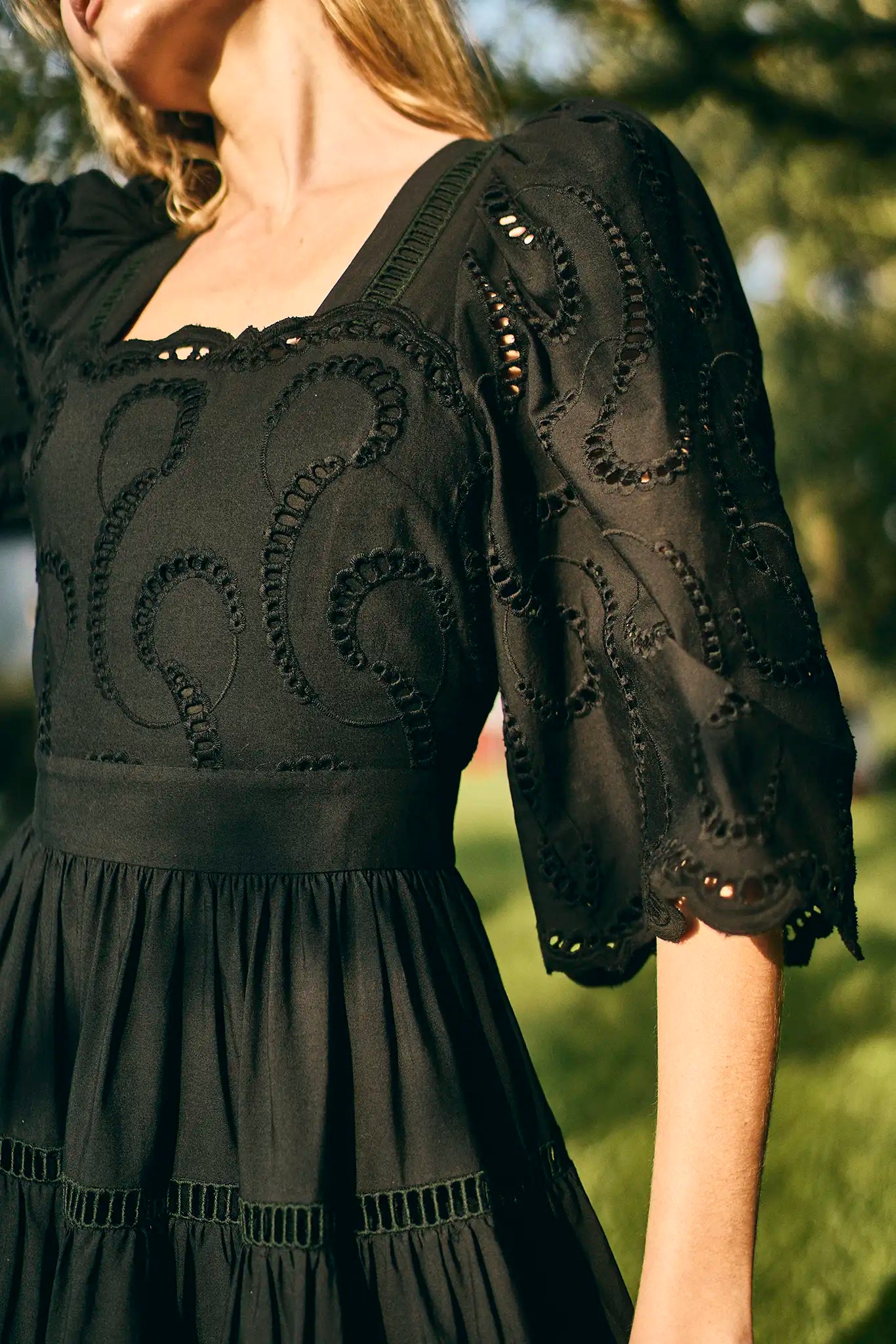 The Zadie Dress has a square neckline, flowy elbow-length sleeves, a fitted bodice and a full skirt.