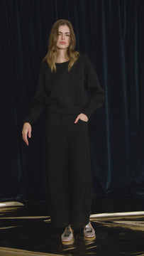 The Jennie Sweatshirt is a structured scuba in deep Onyx with pleated long sleeves.