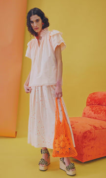 The HB Millie top features a v-neckline, ruffled collar, flutter sleeves and a keyhole opening.