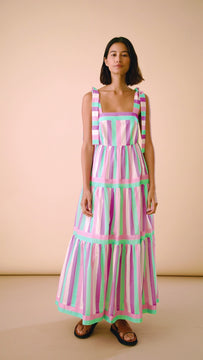 The Jessica dress is a maxi dress with a square neckline, tie shoulder straps and side pockets.