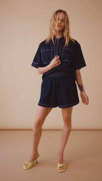 The Jules collared denim shirt is a short sleeve top with patch front pockets & contrast stitching.