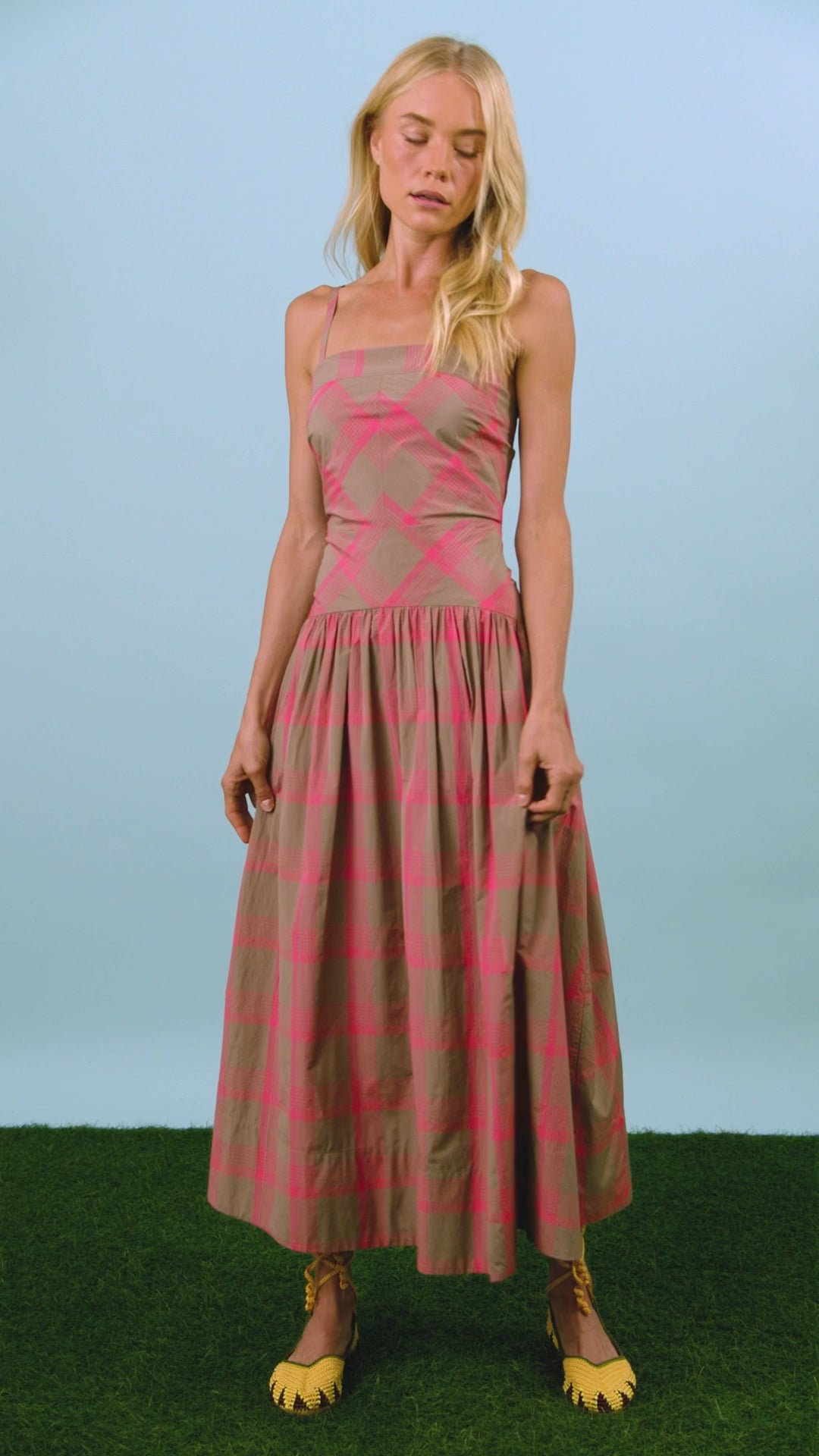 A pink and brown yarn-dyed plaid with slim spaghetti straps, subtle drop waist, and shirred skirt.