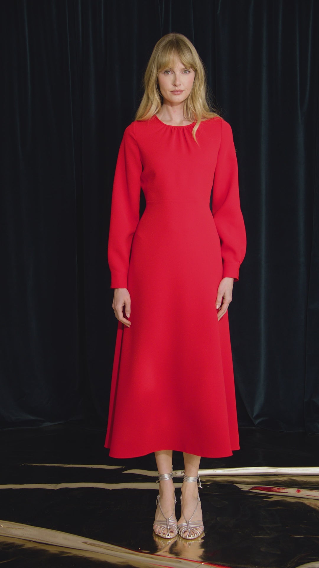 The Delancey Dress is long-sleeve with a shirred round neckline, banded cuffs, and a full skirt.