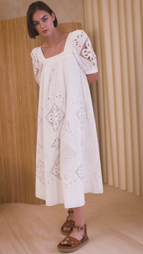 The Waverly dress has a square neckline, elbow-length sleeves, eyelet details and pleat accents.