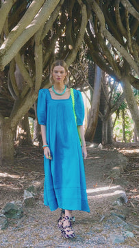 The Waverly is a trapeze maxi dress with a square neckline, elbow length balloon sleeves and pleats.