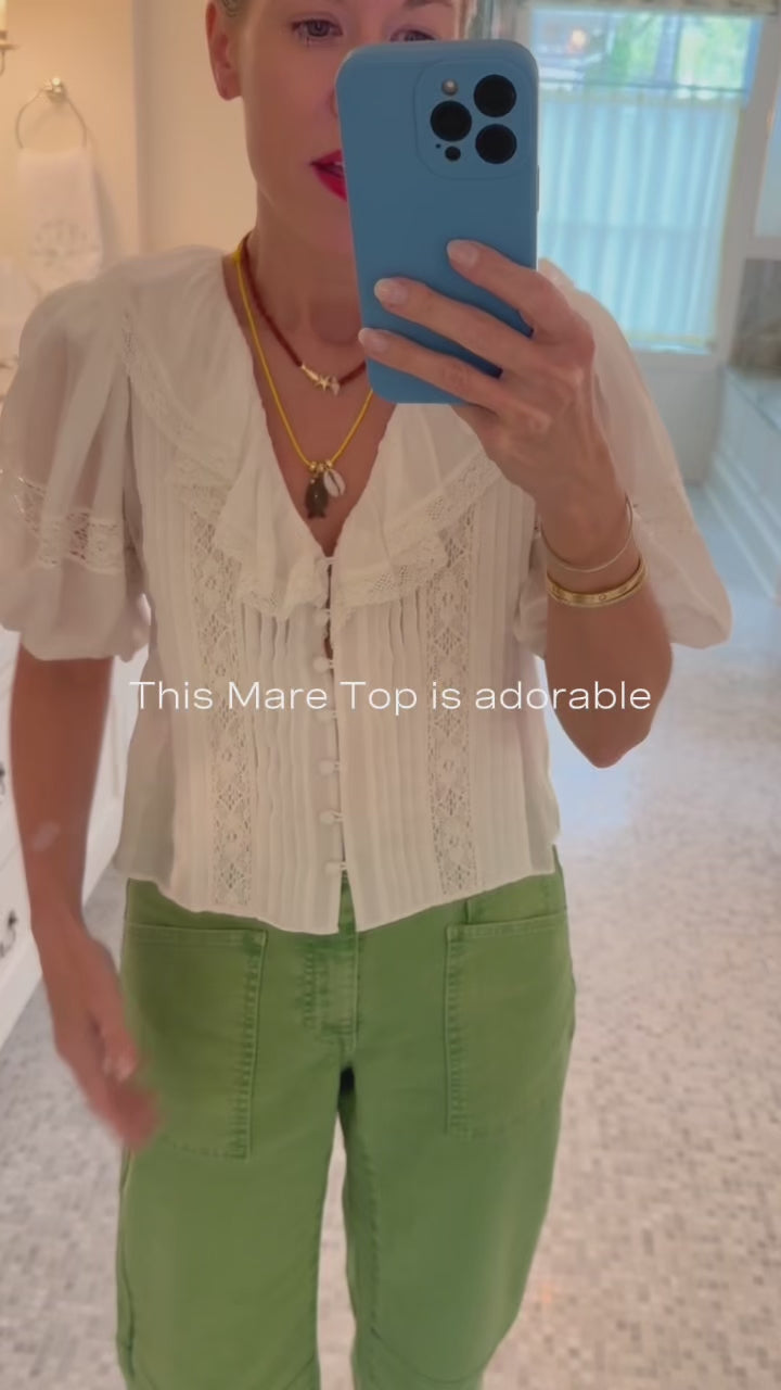 Hunter Bell in the Mare Top in white with the Mallory Jeans in Leaf Green Denim.