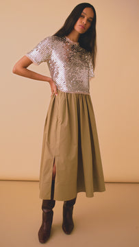 The Pixie sequin top has chiffon trim at the neck, sleeves, and hem.