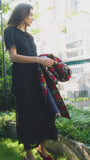 The Whitney Dress in Manhattan Chiffon Onyx paired with the Portman Coat in Palais Floral Gold.