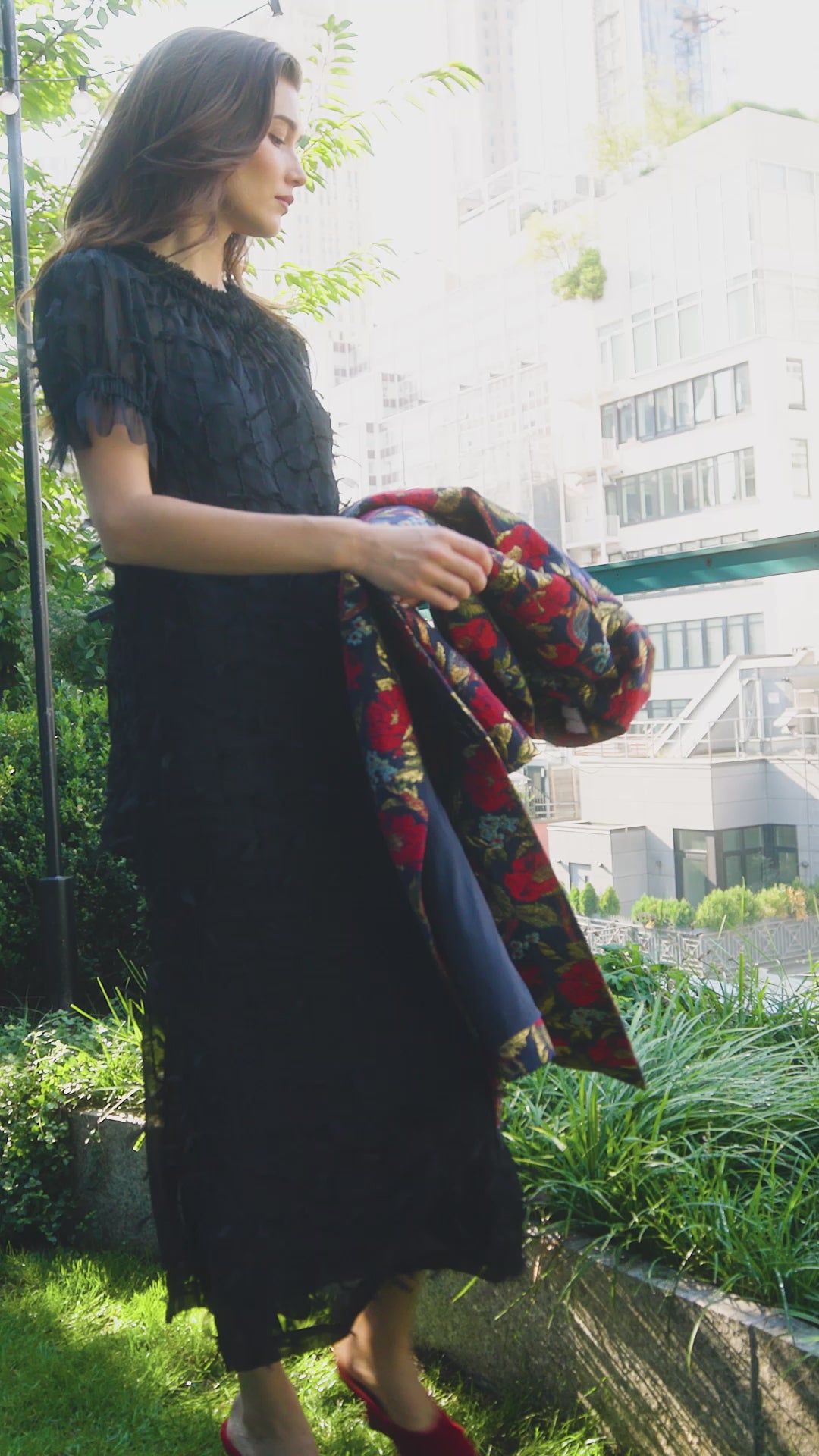 The Whitney Dress in Manhattan Chiffon Onyx paired with the Portman Coat in Palais Floral Gold.