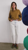 The Opal Sweater in Chestnut paired with the Wray Pant in washed blue denim. 