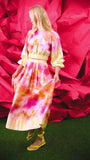 A pleated full skirt in a colorful print with a matching long sleeve top