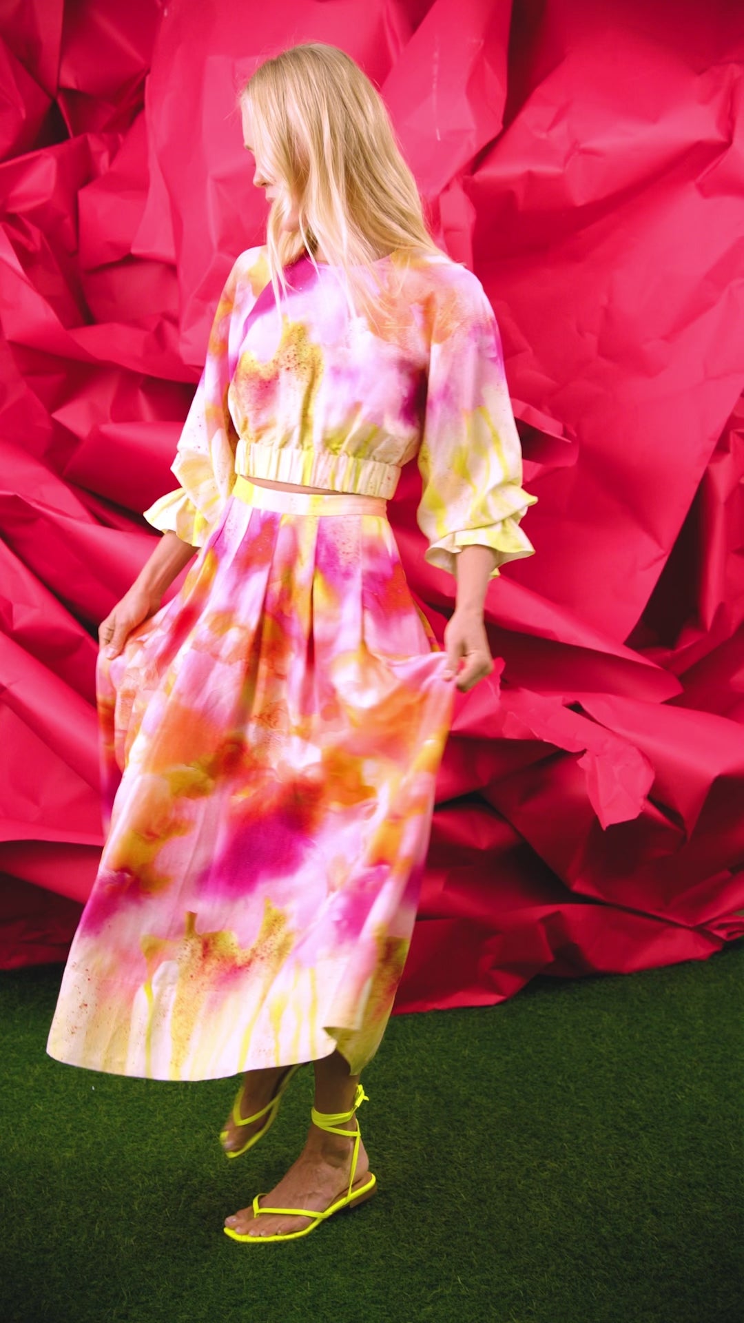A pleated full skirt in a colorful print with a matching long sleeve top