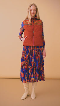 The Brady Vest is a puffer vest with a refined collared neckline and a knitted Fair Isle yoke.