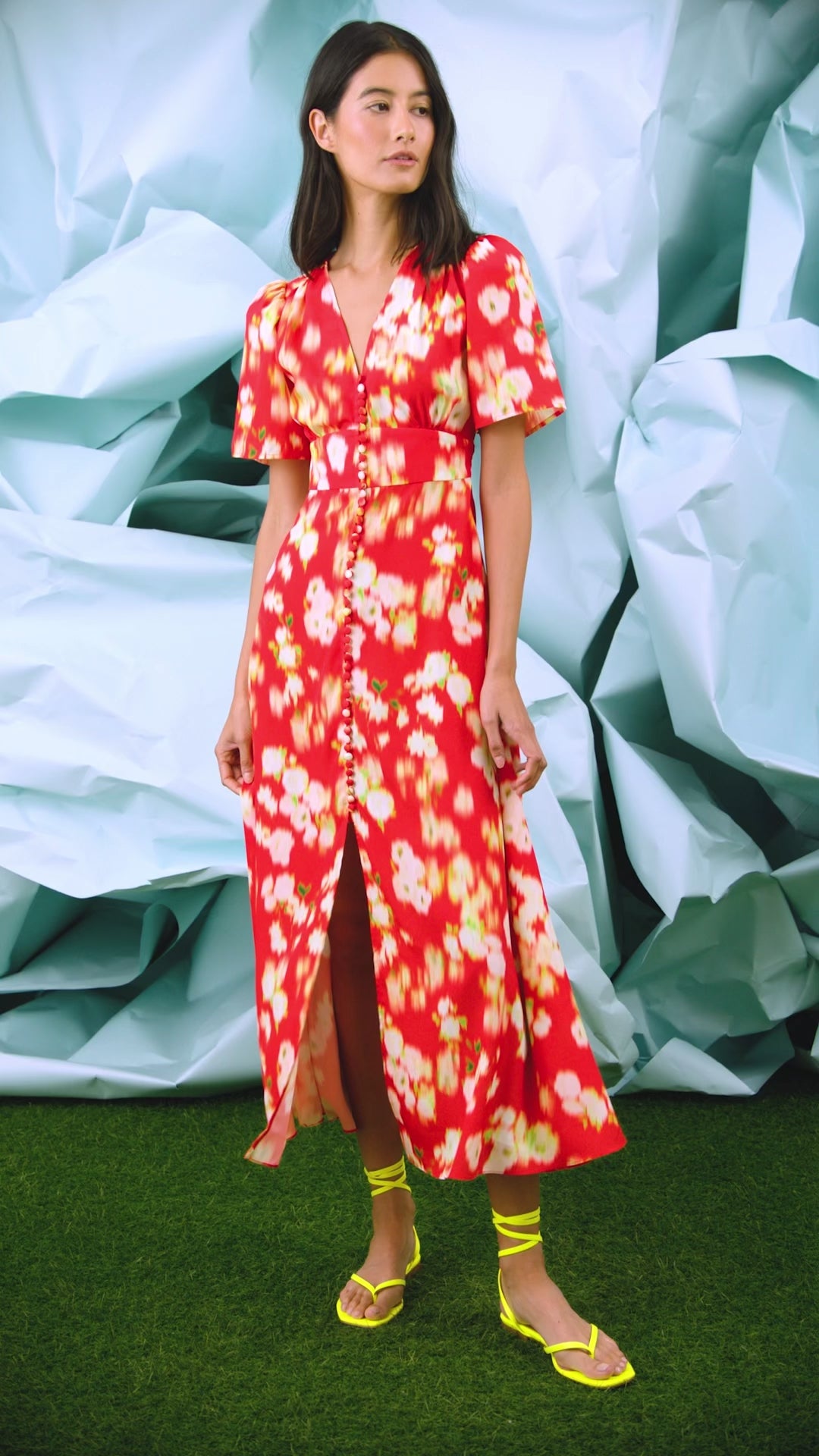 An A-line fitted waist midi dress in an orange and yellow print