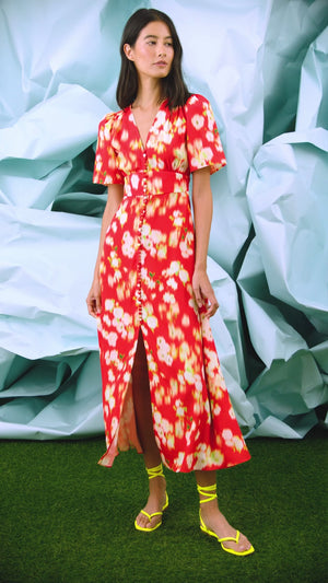 An A-line fitted waist midi dress in an orange and yellow print