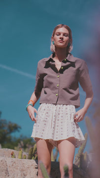 The Scout Top in Army Green features a camp collar, wide cut short sleeves, and neon yellow buttons.
