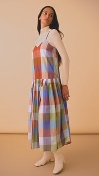 The Martin plaid midi dress has a v-neckline, spaghetti straps, drop waist and a shirred skirt.