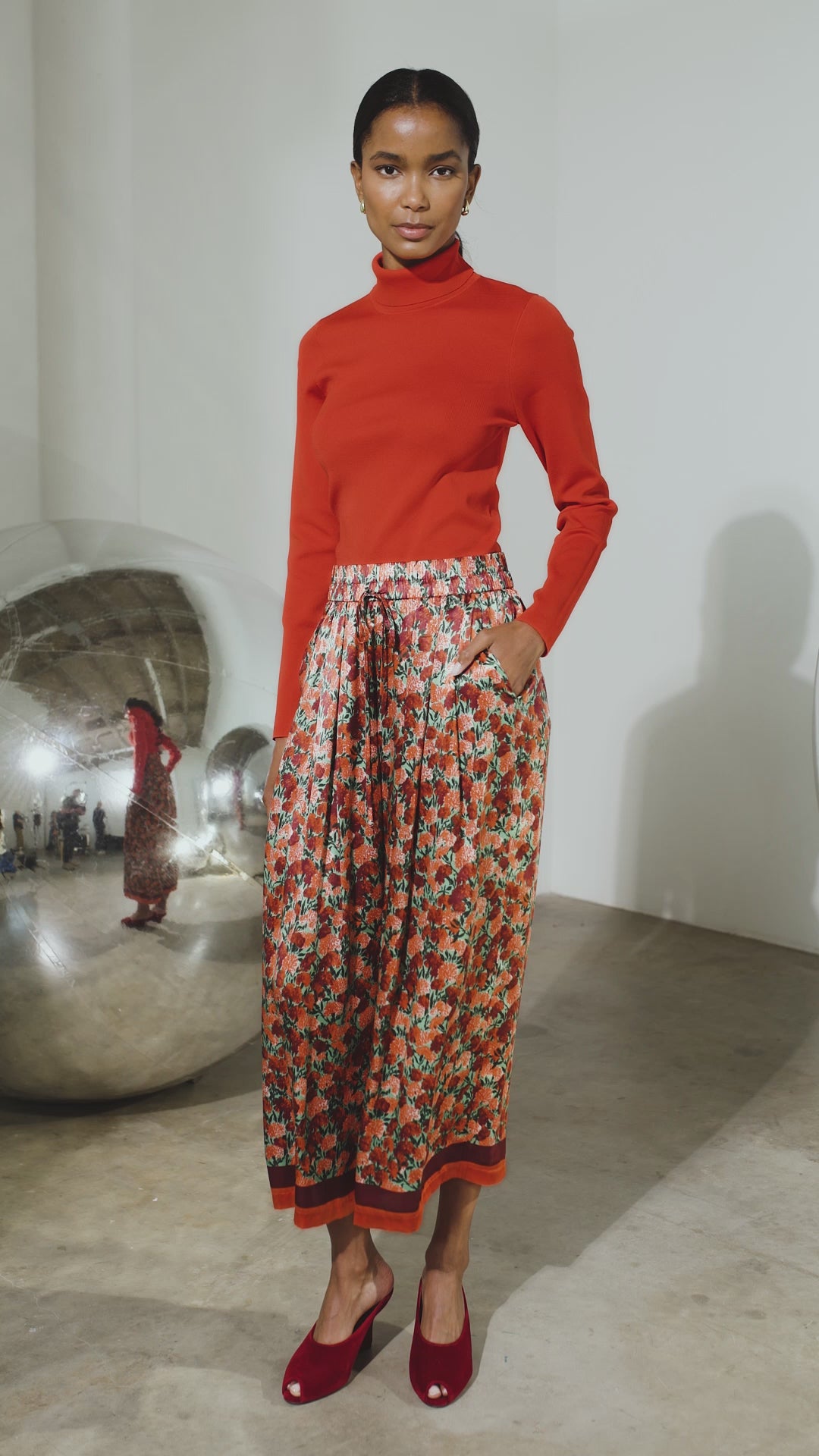 The Roen Turtleneck in Crimson Red paired with the Whisper Pant in Crimson Blossom.