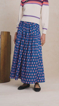  A tiered maxi skirt with ruffle seams, on-seam hip pockets, hidden side zipper and tie detailing.