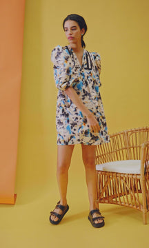 The Jenkins dress has inserted ladder trim, a v-neckline, partial button placket, and puff sleeves.