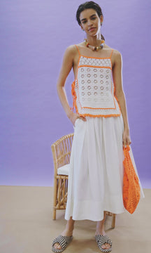A crochet tank with tie shoulder straps, side ties, a contrast neon border and straight neckline.