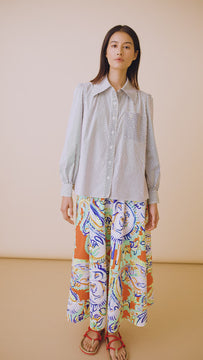 The Jade shirt is a long-sleeve collared shirt with roll-tab sleeves and white stone embellishments.