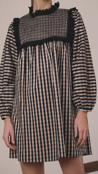 The Carlyle dress has a smocked neckline, button cuffs and a smocked bodice yoke with lace trim.