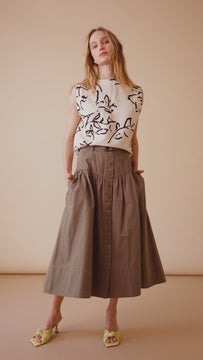 The Delaney belted midi skirt has a high hip, fitted waist, and a wide banded waist yoke.