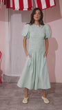 The Scarlet Dress in Saltwater paired with pale yellow shoes.