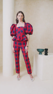 This peplum and puff sleeve plaid top has a fitted bust and semi square neckline.