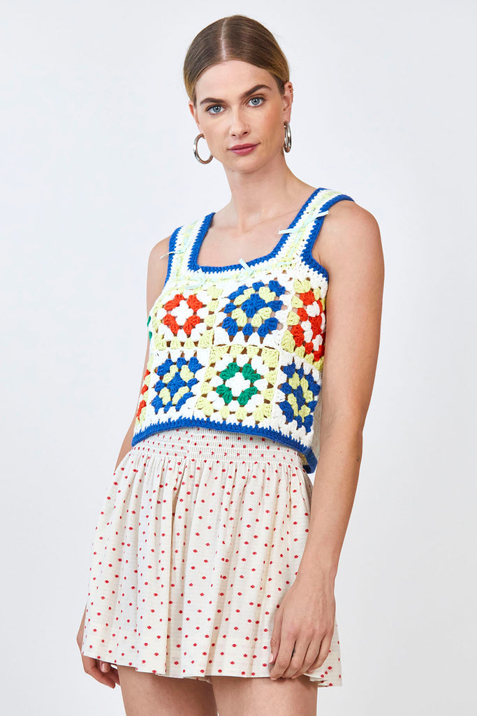 The Hazel crochet top, features a square neckline with wide shoulder straps and a cropped profile.