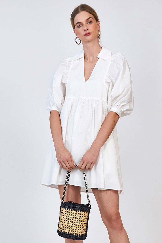 The Noah Dress is a relaxed fit collared shift dress featuring a v-neckline and hidden hip pockets.